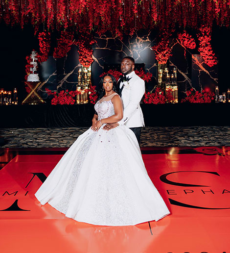 Bride and groom on a candlelit ballroom stage
